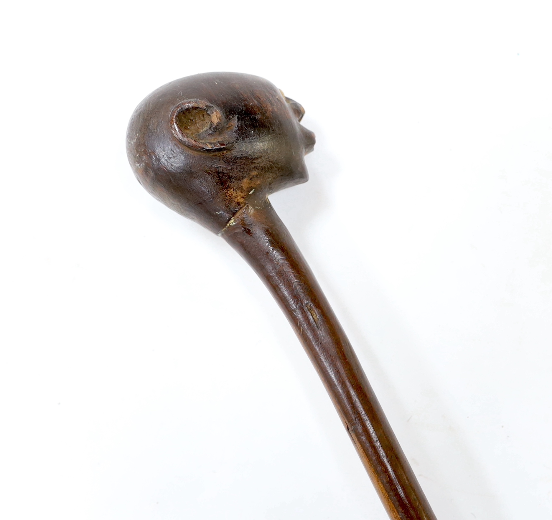 An African carved ebony walking stick, Gogo tribe, Tanzania, with inset eyes, 128cm (damage to foot)